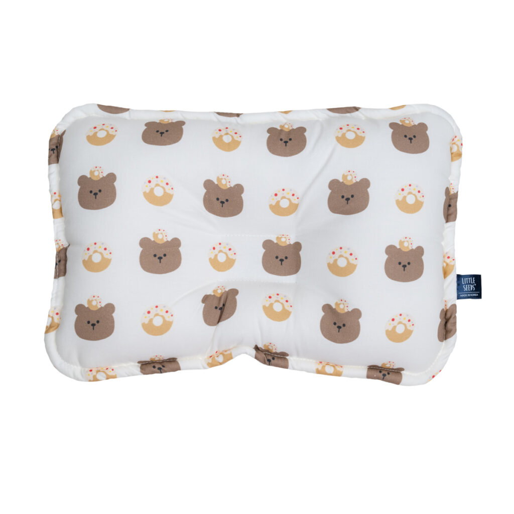 Little Seeds baby pillow with golden donuts and bear on white background