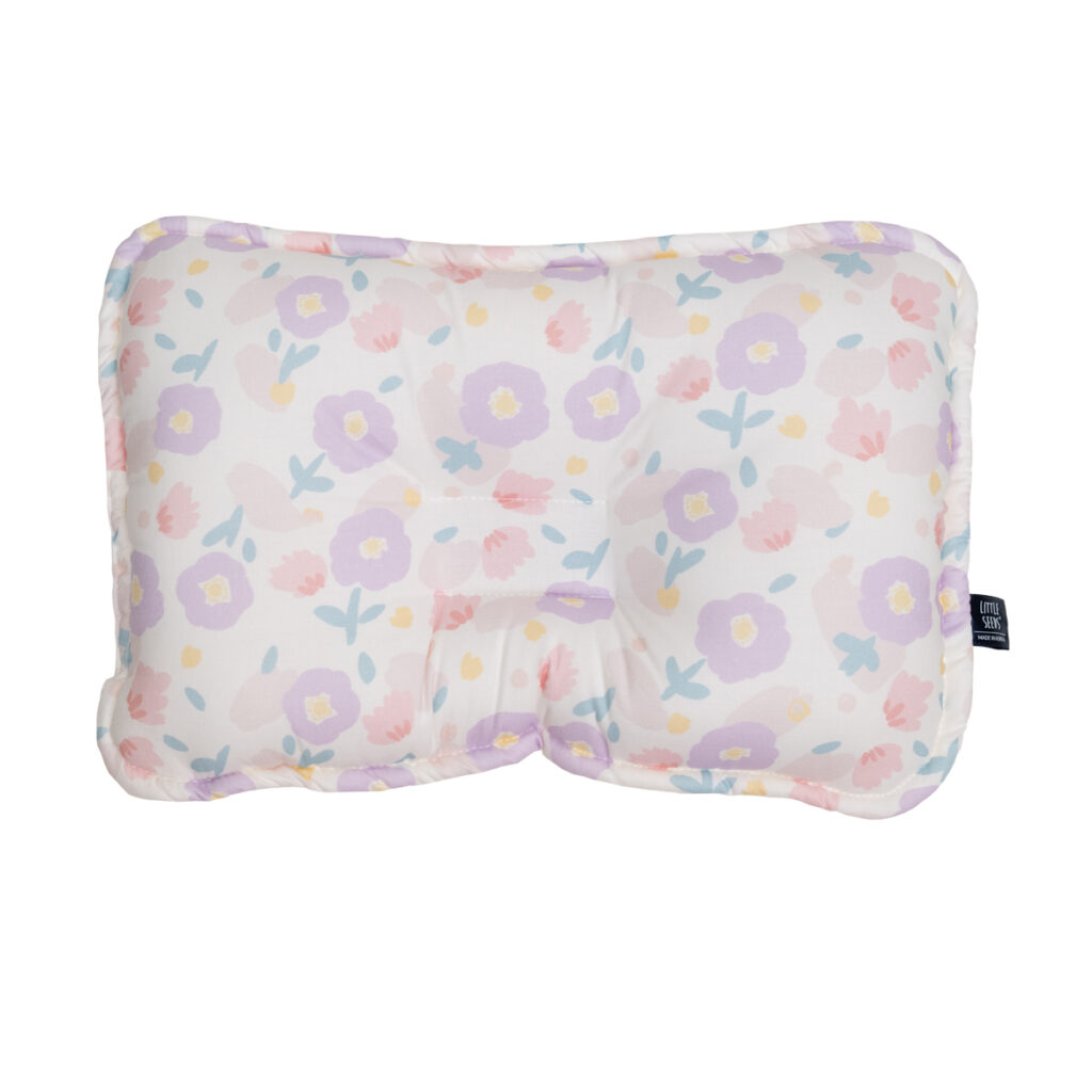 Little Seeds baby pillow with purple flowers on white background